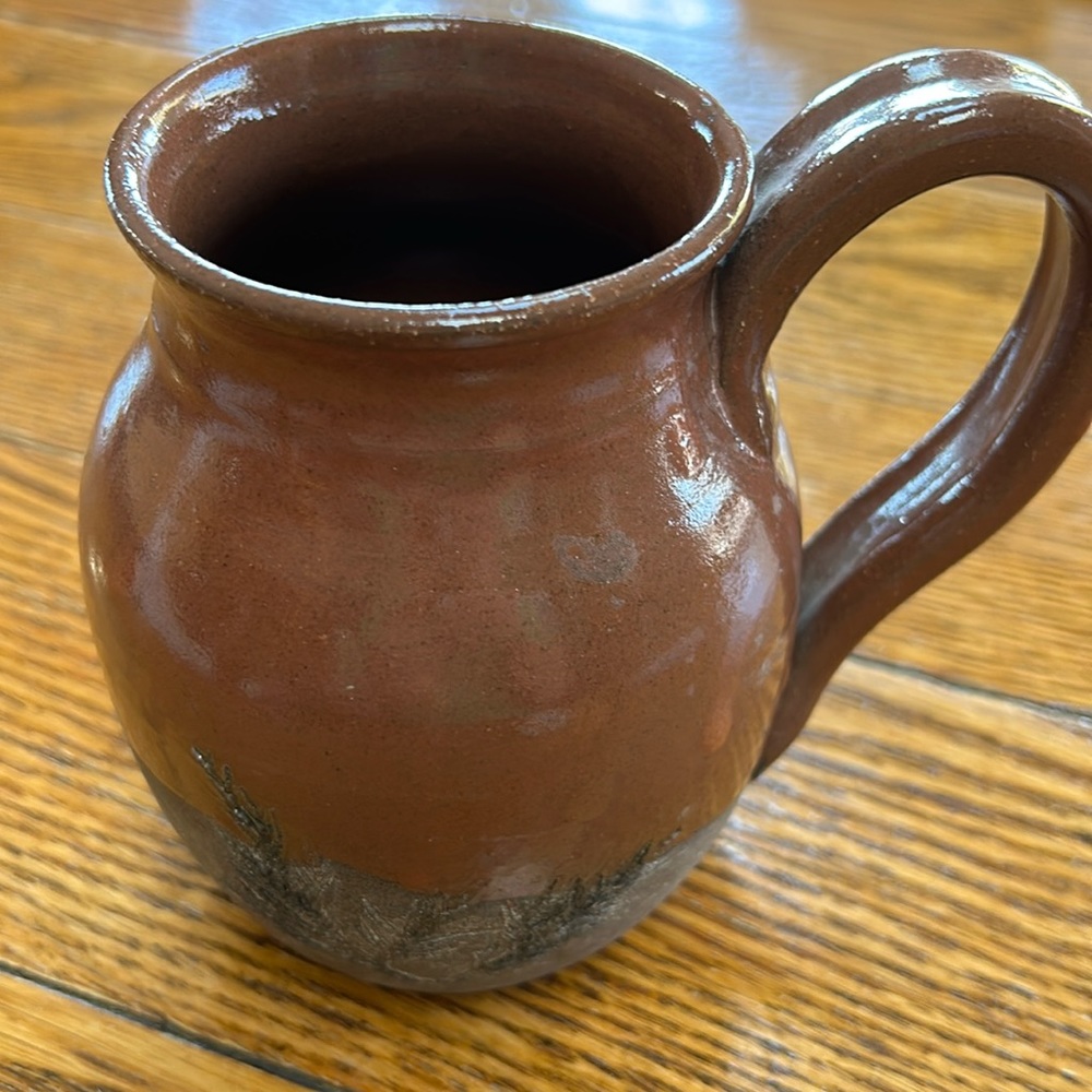 Brown artist created pottery mug.  Artist signed Hutchins.  Great condition.